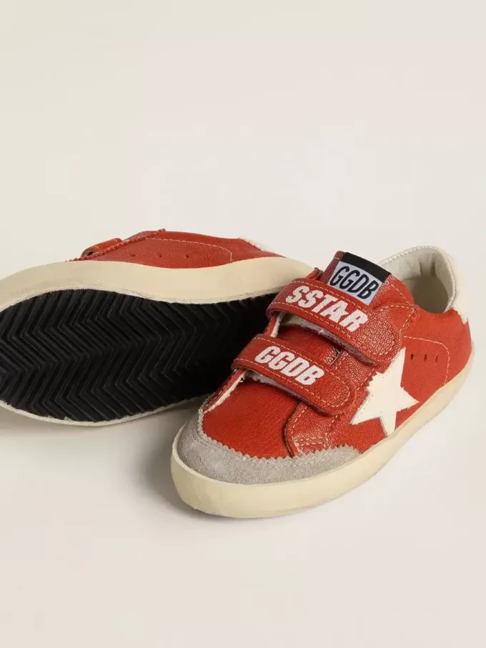 Modèle Junior Old School en cuir nappa orange avec étoile blanche et languette en cuir crème au talon. Modèle Junior Old School en cuir nappa orange avec étoile blanche et languette en cuir crème au talon.