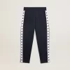 Pantalon de jogging bleu foncé avec bande blanche et étoiles contrastées