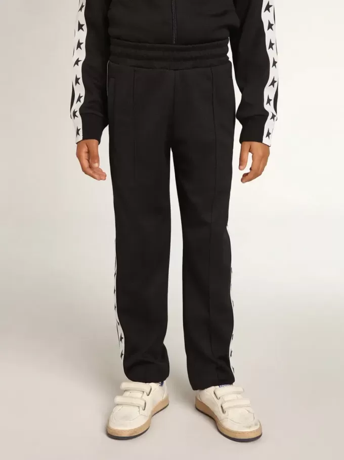Pantalon de jogging bleu foncé avec bande blanche et étoiles contrastées