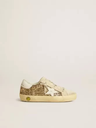 Super-Star Junior dorée pailletée avec étoile et languette au talon en cuir blanc