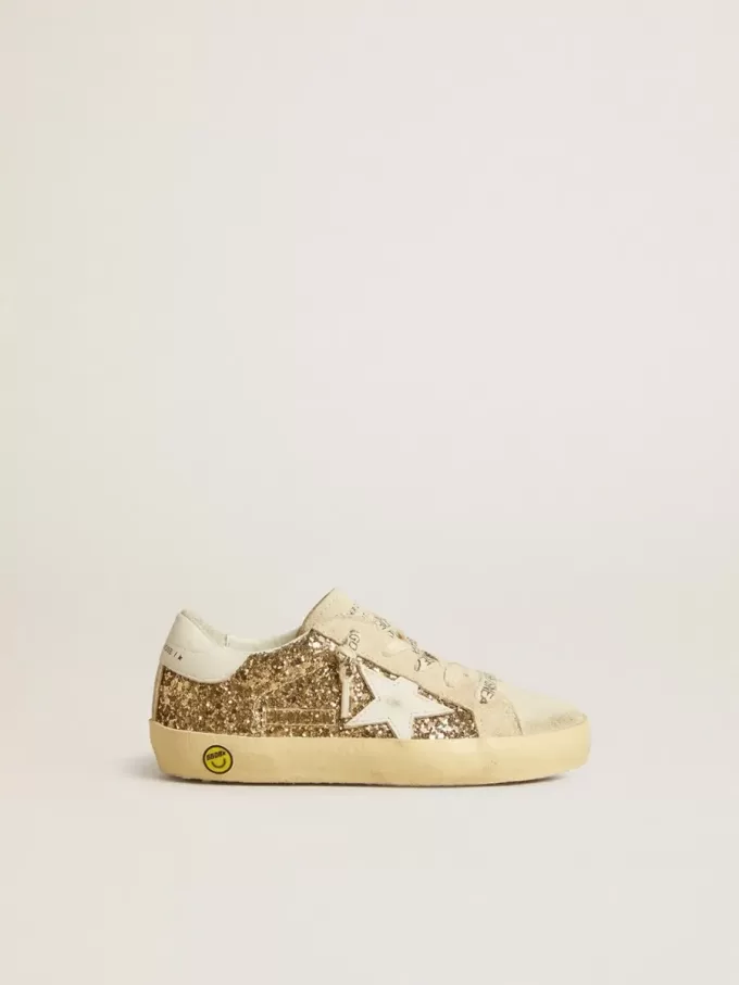 Super-Star Junior dorée pailletée avec étoile et languette au talon en cuir blanc Super-Star Junior dorée pailletée avec étoile et languette au talon en cuir blanc