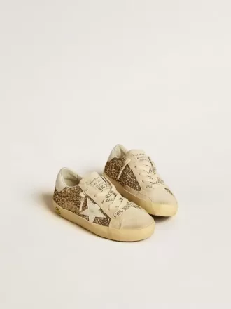 Super-Star Junior dorée pailletée avec étoile et languette au talon en cuir blanc