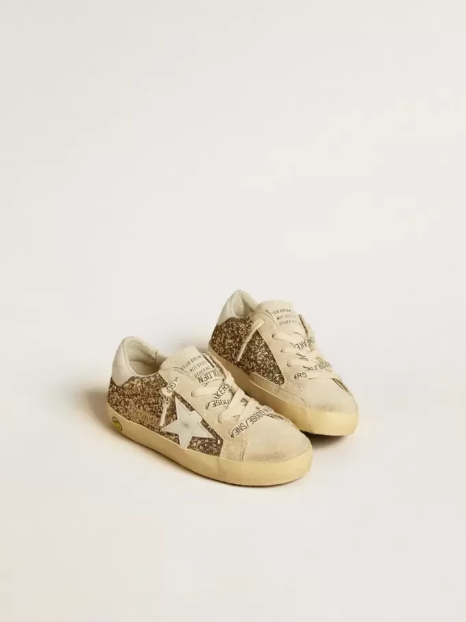 Super-Star Junior dorée pailletée avec étoile et languette au talon en cuir blanc Super-Star Junior dorée pailletée avec étoile et languette au talon en cuir blanc