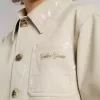 Veste beige pour enfant avec éclaboussures multicolores Veste beige pour enfant avec éclaboussures multicolores